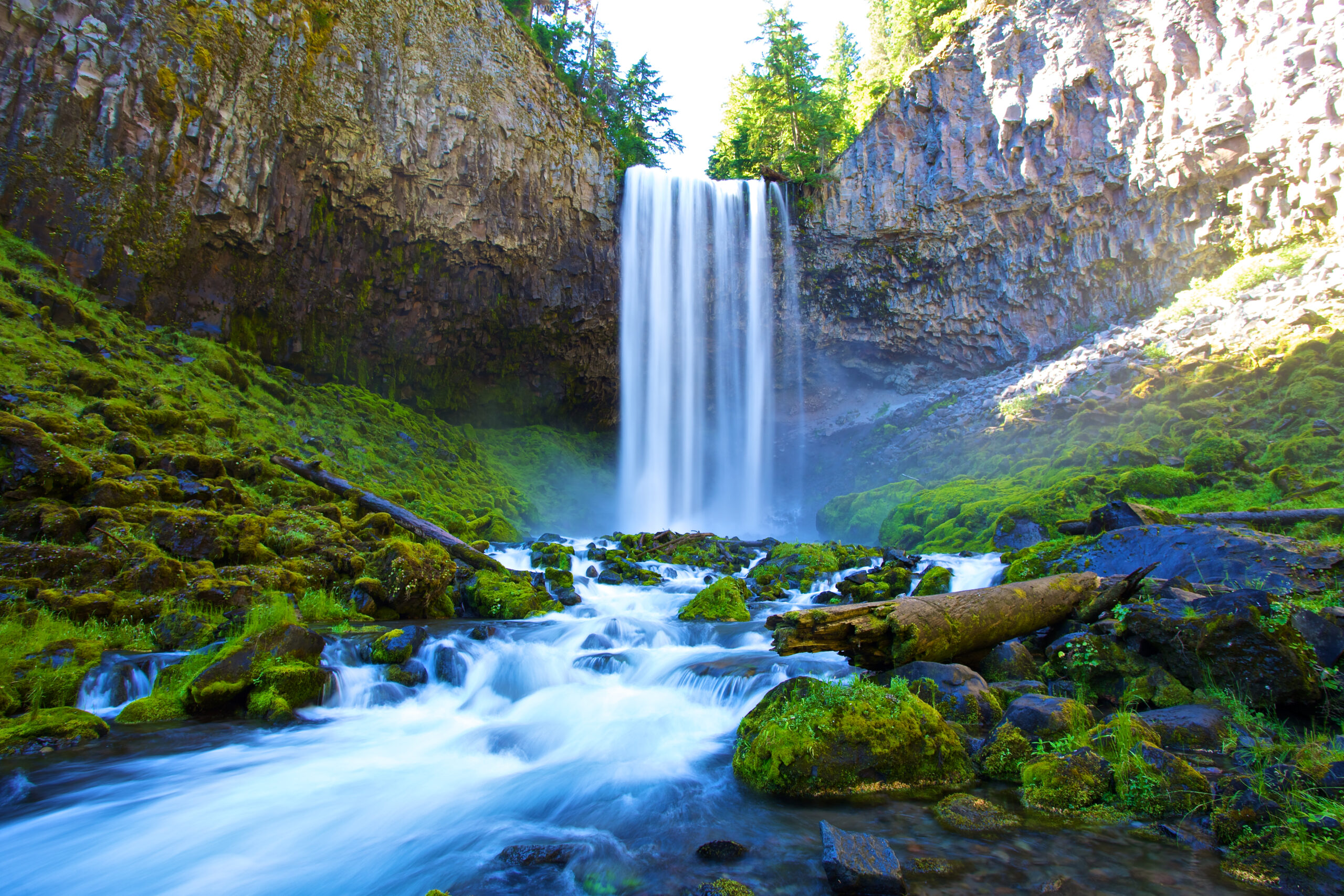 Falls near Hood River, Oregon, surrounded by mossy rocks and forest in summer sun