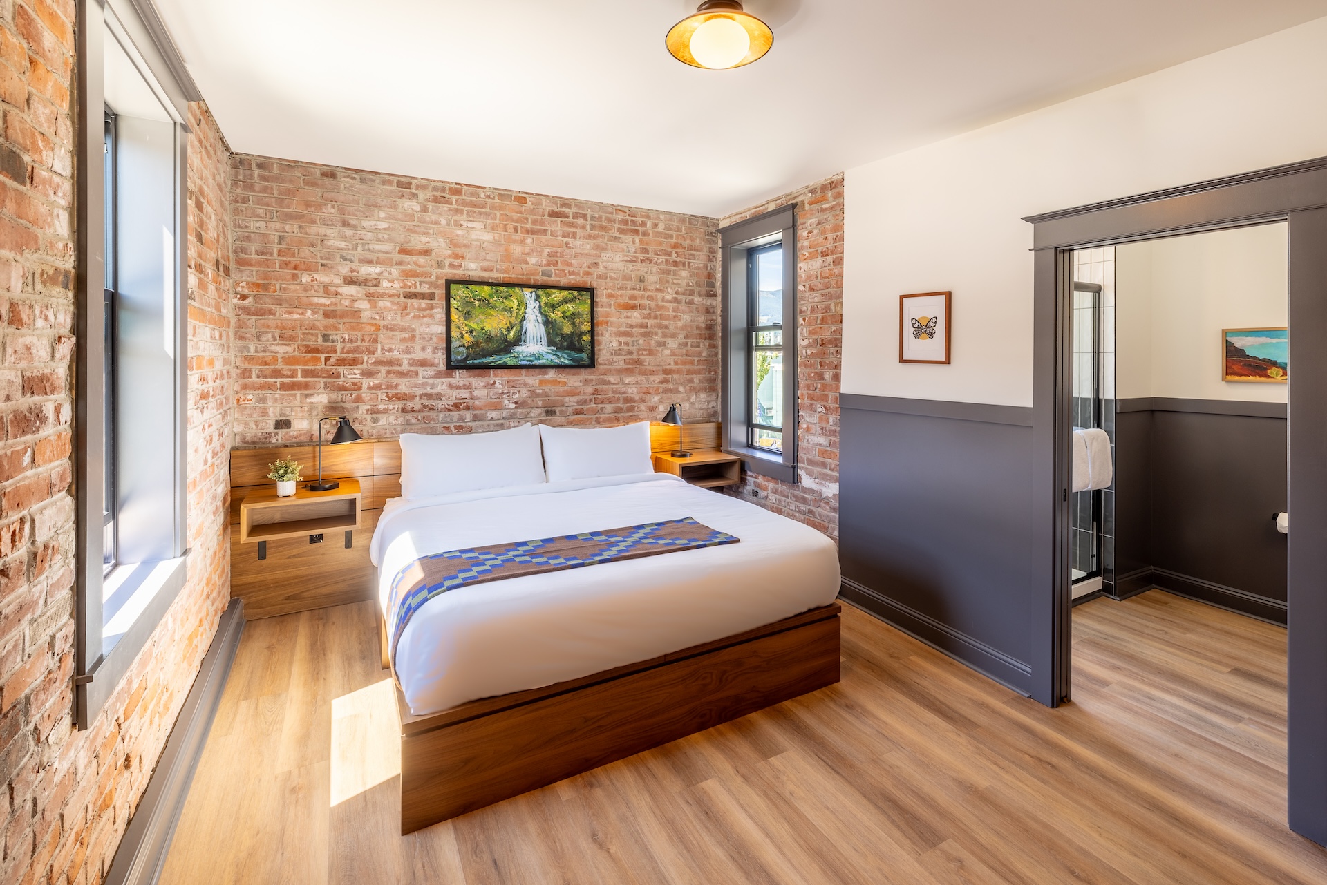Boutique Hood River hotel room featuring City View King bed, natural light, and modern furnishings.