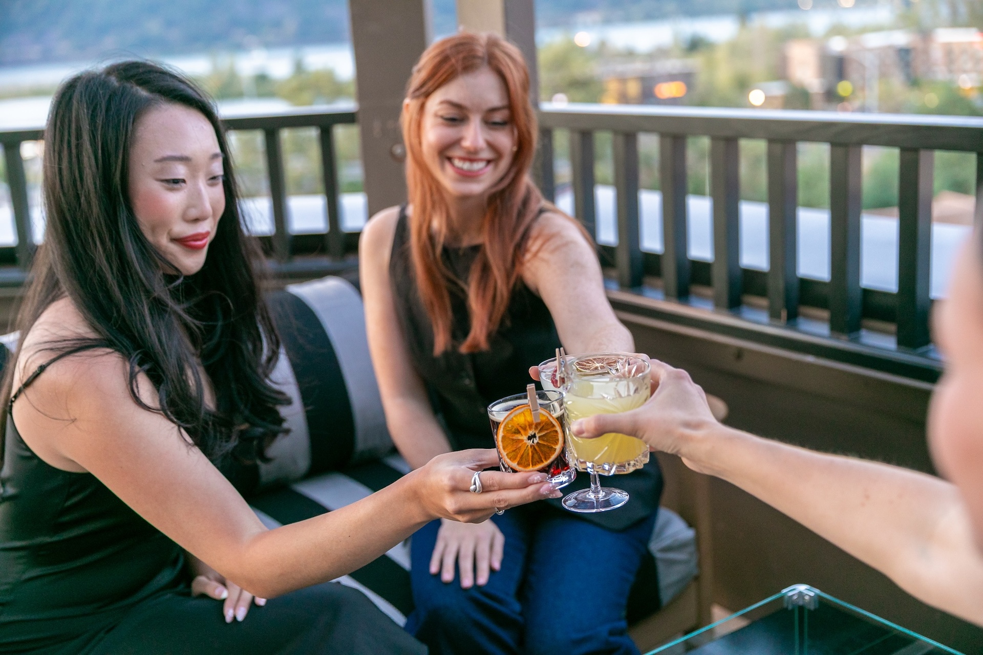 Guests enjoying cocktails at The Rooftop at Lightwell Hotel in downtown Hood River with Columbia River Gorge views.