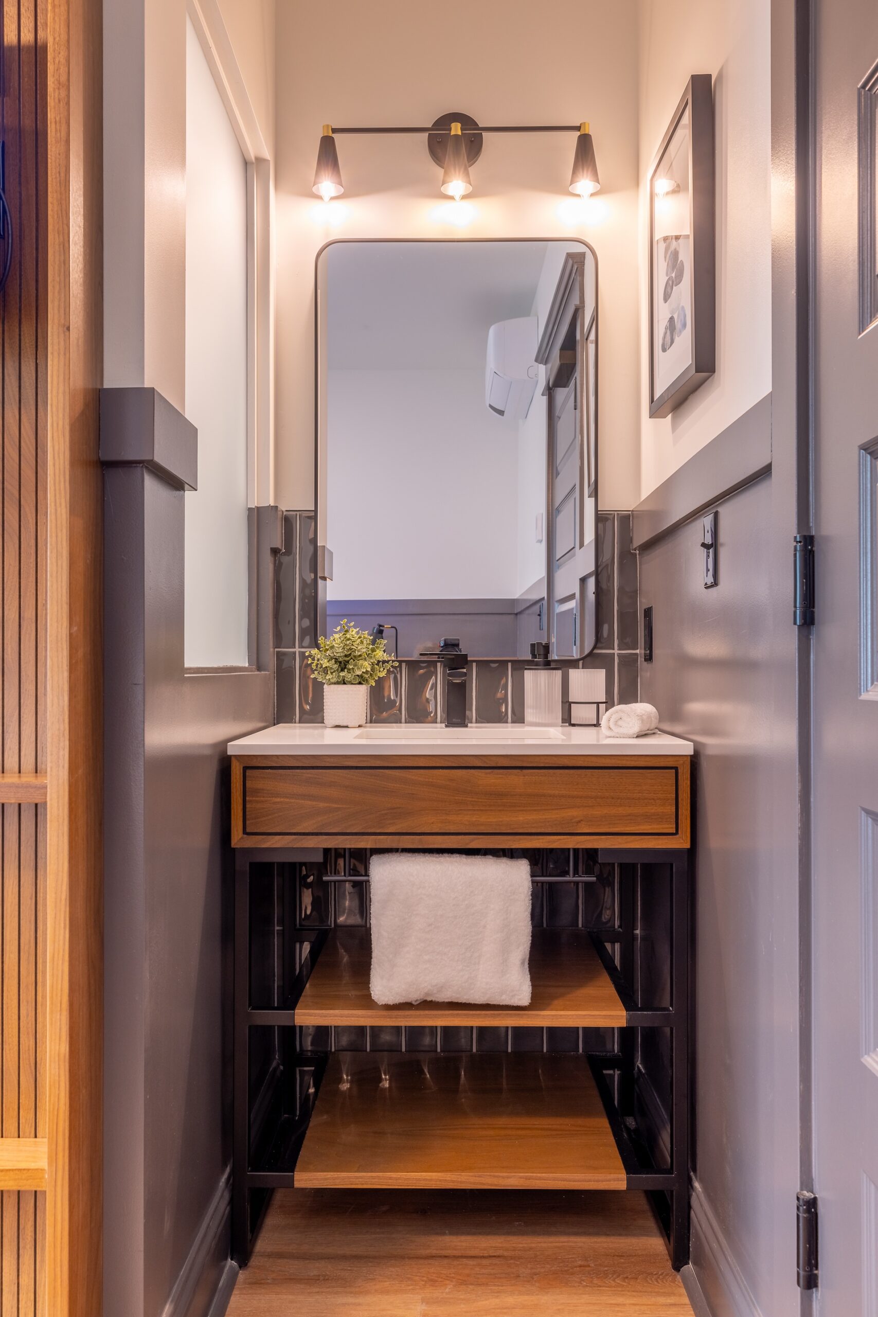 Lightwell Hotel & Spa Queen guest room bathroom vanity with modern lighting, wood accents, and sleek design in Hood River.