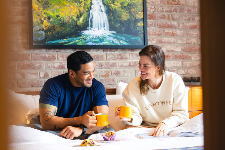 Couple enjoying in-room breakfast at Lightwell Hotel
