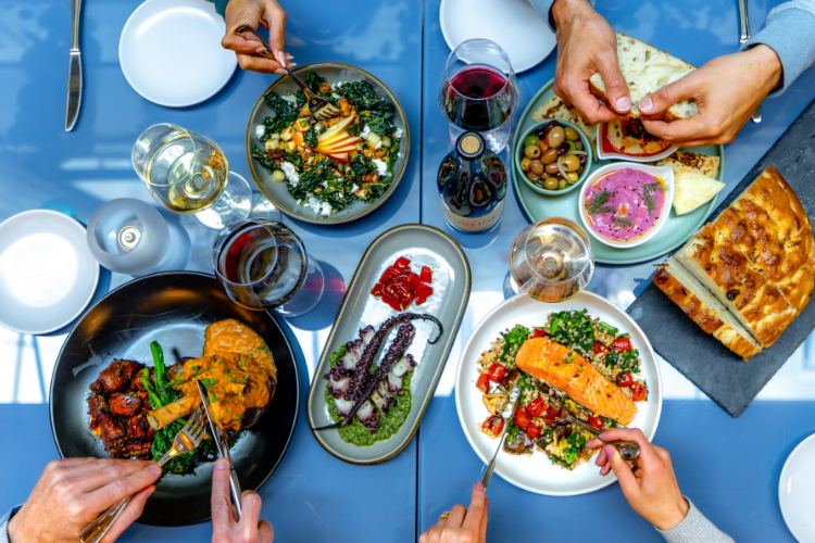 A table filled with Pacific Northwest Mediterranean dishes at Alia in Hood River, featuring vibrant shared plates, fresh ingredients, and seasonal flavors.