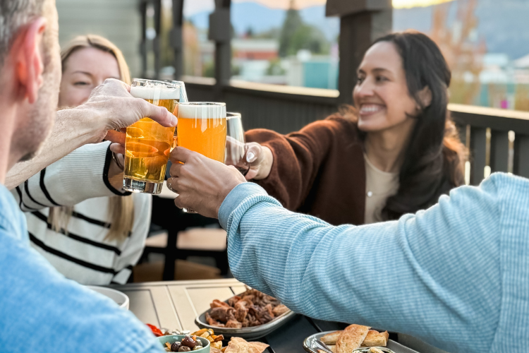 Guests dining and enjoying drinks on the rooftop at Lightwell Hotel in Hood River, Oregon.
