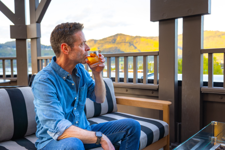 Guest enjoying a rooftop cocktail at sunset, overlooking the Gorge.